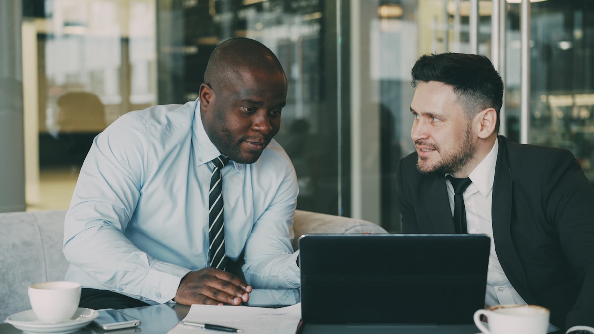 Two professionals from different backgrounds in a focused conversation, representing live interpretation