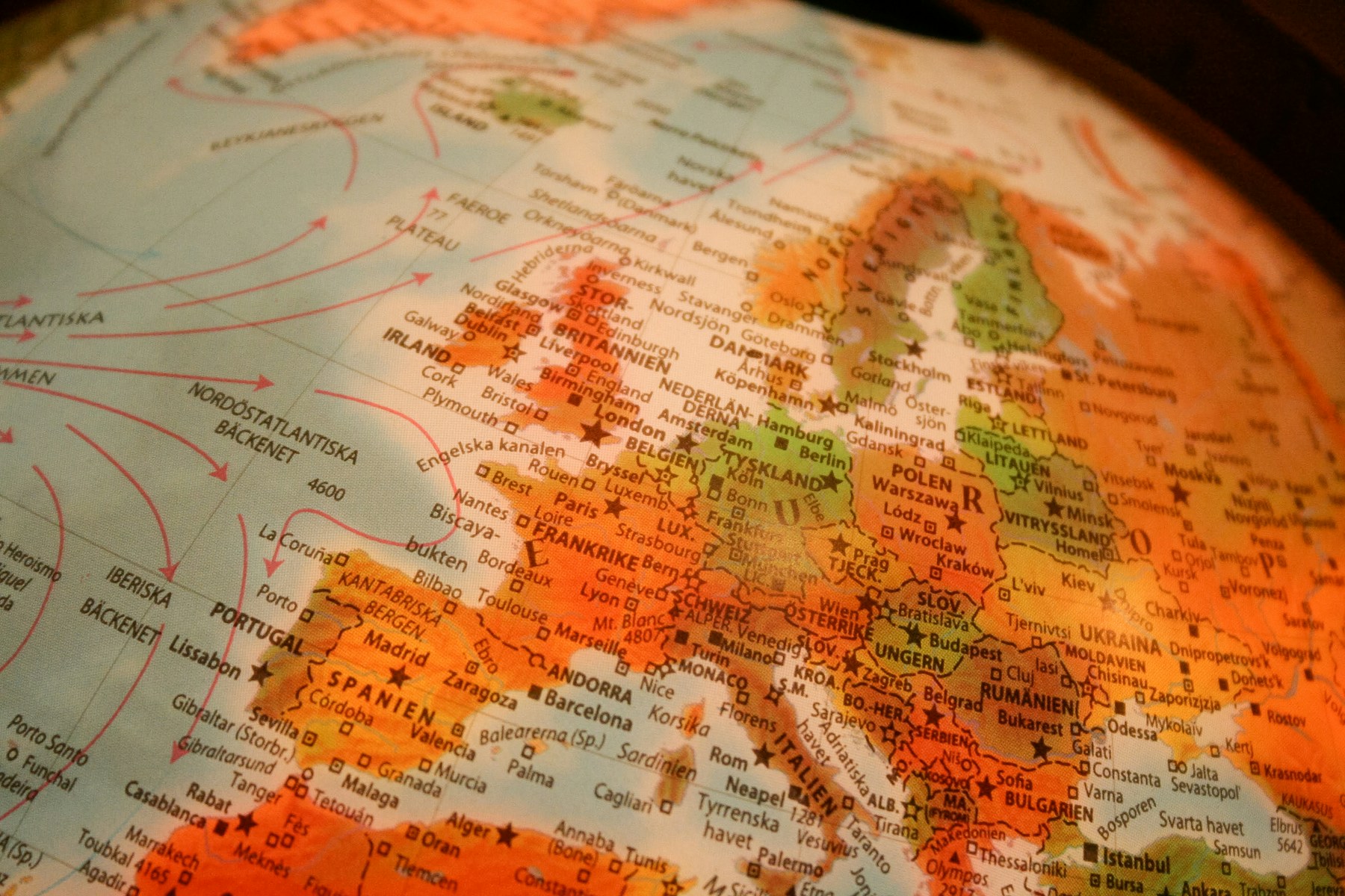 Close-up of a globe with country names in multiple languages, evoking world languages and reaching out across communities